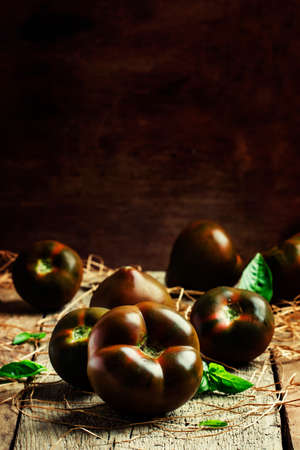 Large black tomatoes, rustic style, selective focusの写真素材