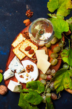 White Dry Wine, Cheese With Mold, Nuts, Grape And Cracker, Dark Background, Top View