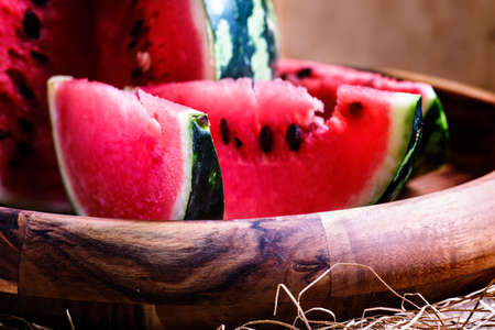 Chunks of of watermelon, rustic style, old wooden background, selective focusの写真素材