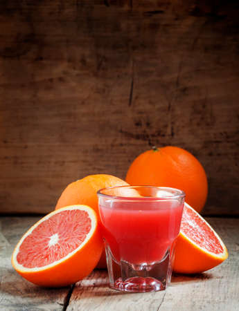 Juice of red Sicilian oranges in a large glass, selective focusの写真素材