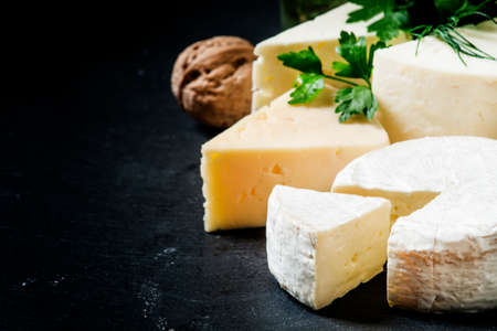 Cheese Assortment on a dark background, selective focus