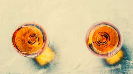 Strong alcoholic drink in two glasses, toned image, top viewの写真素材