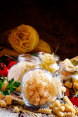 Dry Italian pasta spiraline in glass jars, selective focusの写真素材