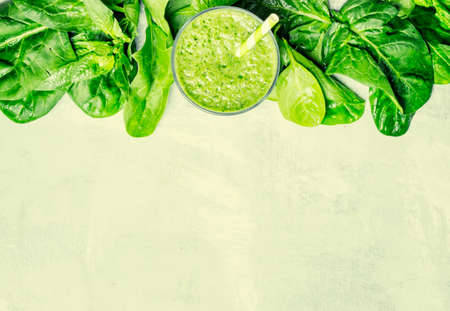 Cocktail of spinach and green vegetables and fruit, drink background, top view