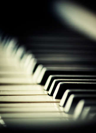 Piano keys, imitation of old photos with grain, selective focus, shallow depth of field