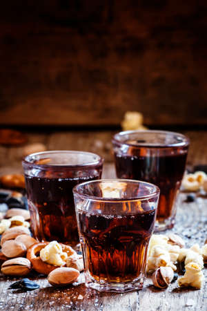 glasses, sweet and savory snacks, old wooden table, unhealthy food, selective focus