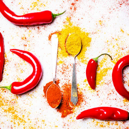 Ground chilli, yellow turmeric and fresh hot red pepper, top view