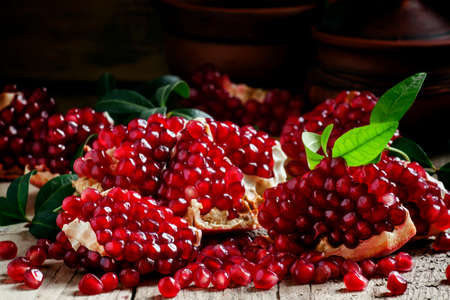 Azerbaijan peeled pomegranate on the old wooden table on a dark background, selective focusの写真素材