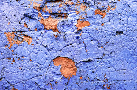 Concrete gray wall with peeling blue paint texture or background. High contrast and resolution image...