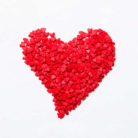 Red heart from sweet sugar hearts, Valentine's Day card, light background, top viewの写真素材