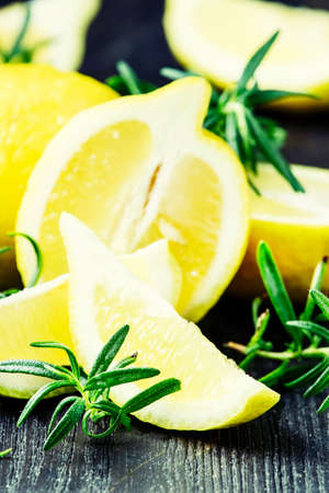 Lemon and rosemary, black background, selective focusの写真素材