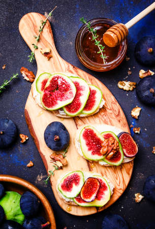 Sandwiches with cottege cheese, blue figs, thyme and honey, top viewの写真素材