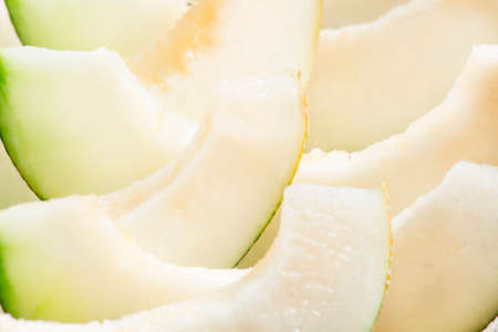 Ripe sliced melon on a wooden background, selective focusの写真素材