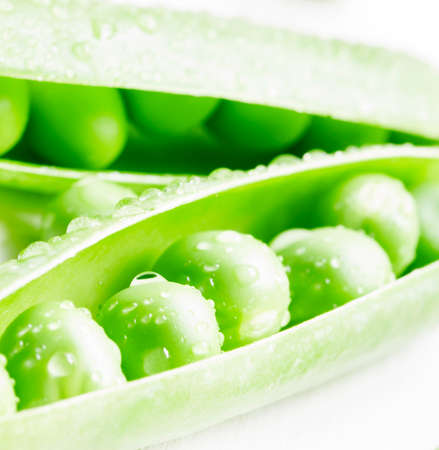 Green peas, twine vines and flowers on white wooden background, not isolated, macro shot, selective focusの写真素材