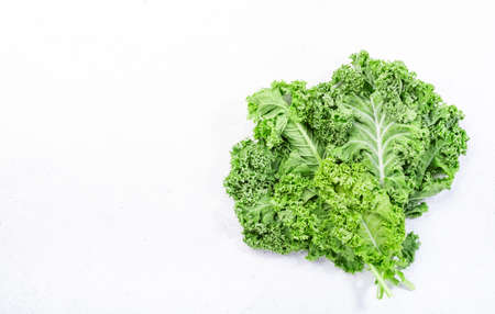 Kale cabbage. Green vegetable leaves, top view on white background, healthy eating, vegetarian foodの写真素材