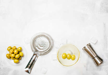 Martini and vodka, alcoholic cocktail with olives, gray background, top view
