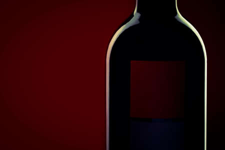 Red wine bottle silhouette on red black backgroundの写真素材