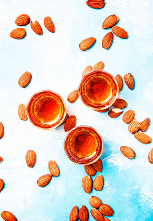 Almond liqueur on blue stone background, top viewの写真素材