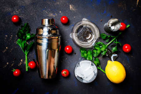 Preparing alcoholic cocktail with tomato, lemon juice, hot sauce, celery and vodka, black background, top viewの写真素材
