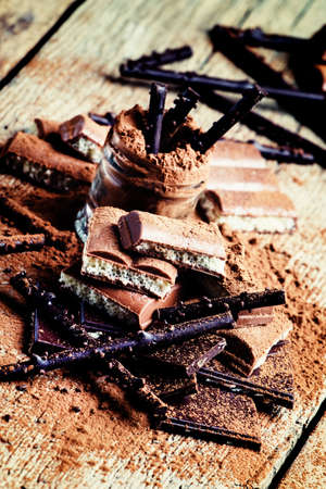 Chocolate and cocoa powder mix, vintage wooden background, rustic style, selective focus