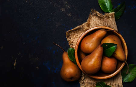Fresh autumn brown pears in a bowl, top viewの写真素材