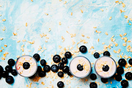 Blueberry yogurt with fraesh berry and oat flakes, top view