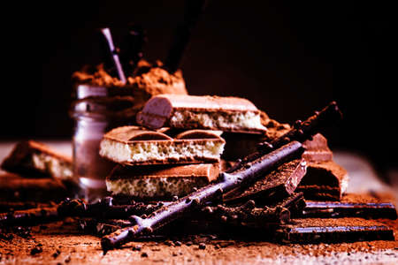 Chocolate and cocoa powder mix, vintage wooden background, rustic style, selective focus