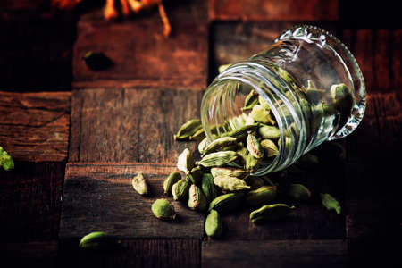 Dry whole cardamom, vintage wooden background, selective focusの写真素材