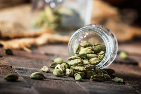 Dry whole cardamom, vintage wooden background, selective focusの写真素材