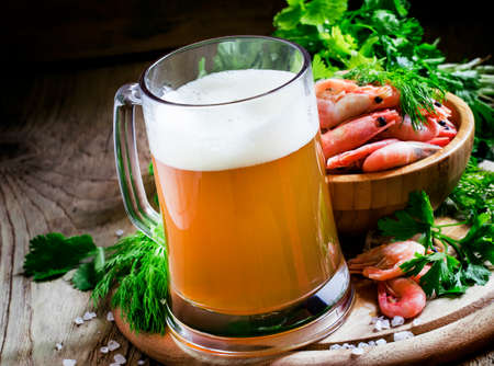 Beer and shrimp, vintage wooden background, selective focusの写真素材