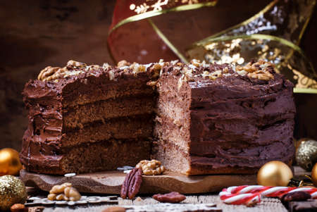 Sliced New Year chocolate cake with walnuts, Christmas dinner, top viewの写真素材
