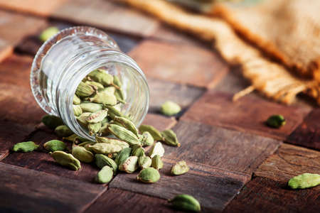 Dry whole cardamom, vintage wooden background, selective focusの写真素材