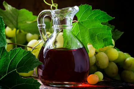 Wine vinegar in a jug. Still life in the rustic style. Selective focus.の写真素材