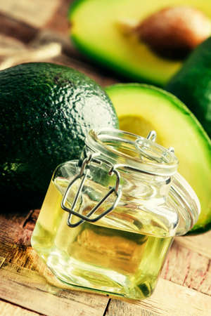 Cosmetic avocado oil in a glass jar, selective focusの写真素材