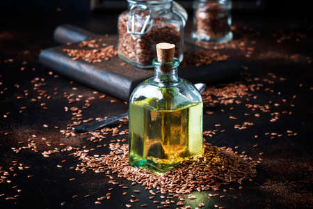 Linen or flax cold pressed oil in bottle, rustic style, vintage background, selective focusの写真素材