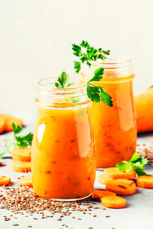 Carrot juice with flax seeds in glass bottles, healthy drink for raw diet, selective focusの写真素材