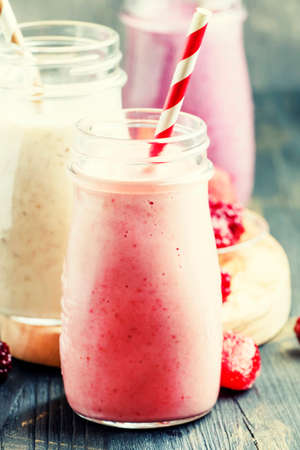 Berry smoothies with yoghurt, gray background, selective focusの写真素材