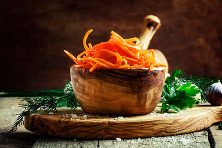 Salad from marinated carrots. Vintage wooden background, selective focusの写真素材