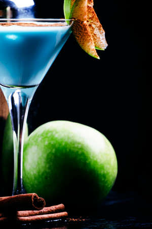 Cocktails with liqueur, cream and green apple, bar tools on a black background, selective focusの写真素材
