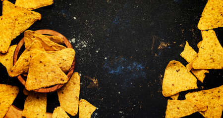 Salted Mexican Corn Nachos iIn Wooden Bowl, Black Background, Top View