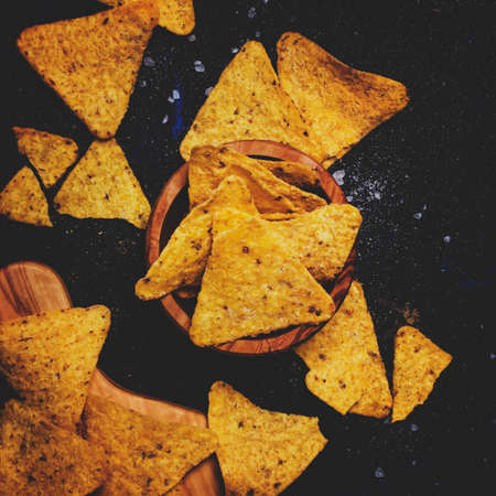 Salted Mexican Corn Nachos iIn Wooden Bowl, Black Background, Top Viewの写真素材