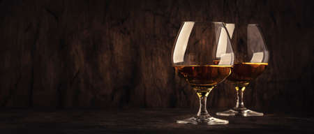 Cognac in a glass, dark background, banner with copy spaceの写真素材