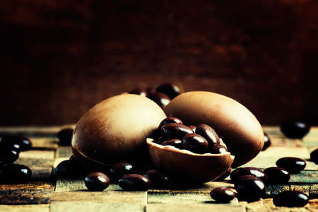 Easter chocolate eggs on a wooden rustic background, selective focus