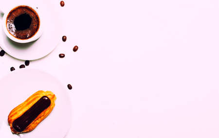 Morning coffee with eclair cake, white background, top view
