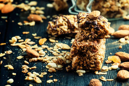 Homemade granola bar with raisins and almonds, selective focus