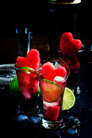 Alcoholic cocktail pasteque with vodka, watermelon juice, lime and ice. Bar tools on dark background, selective focusの写真素材