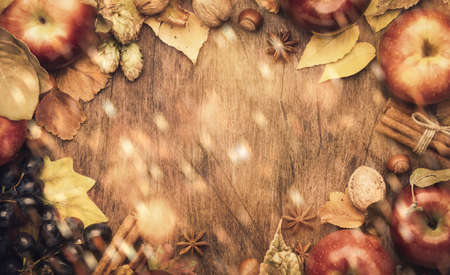 Thanksgiving background, food autumn harvest concept. Rustic table with Apples, pumpkins, nuts, grapes and corn on dark table with copy space, top viewの写真素材