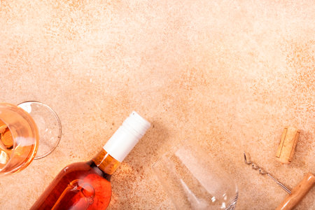 Rose wine glass with bottle on the beige table. Rosado, rosato or blush wine tasting in wineshop, bar concept. Copy Space, top viewの写真素材