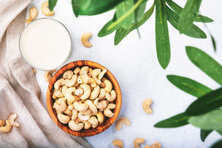 Vegan Cashew nut milk on white background. Non dairy alternative vegan milk. Healthy vegetarian food and drink. Copy space, top viewの写真素材