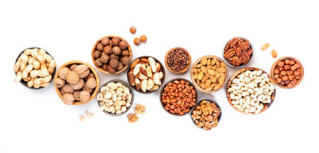 Assortment of nuts in bowls. Cashews, hazelnuts, walnuts, pistachios, pecans, pine nuts, peanuts,...